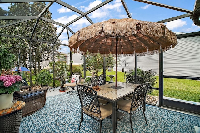 view of patio / terrace featuring glass enclosure and outdoor dining area