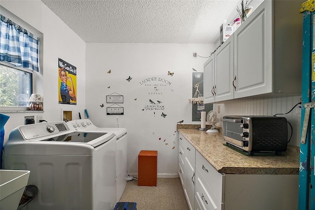 laundry room featuring a textured ceiling, a toaster, a sink, and washer and dryer