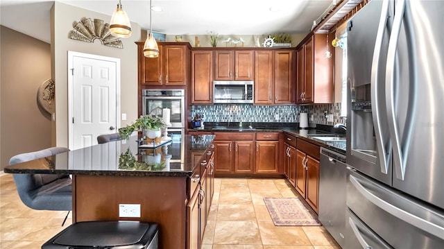 kitchen with a center island, stainless steel appliances, decorative backsplash, dark stone countertops, and a kitchen breakfast bar