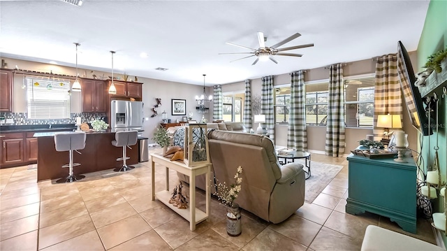 26747 White Plains Way, Leesburg, FL 34748 - living area with light tile patterned floors, ceiling fan, and visible vents
