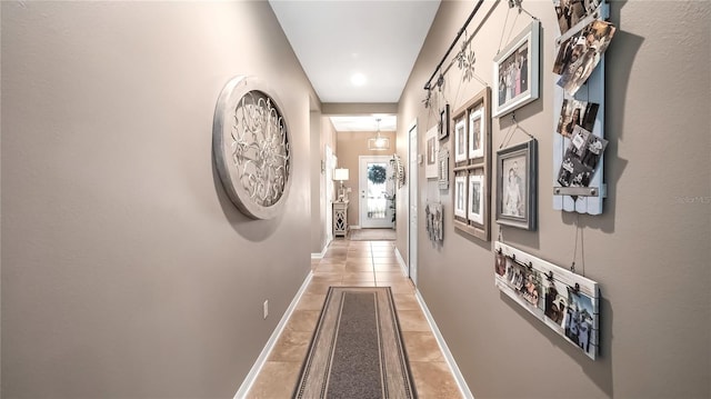 26747 White Plains Way, Leesburg, FL 34748 - corridor featuring light tile patterned floors and baseboards