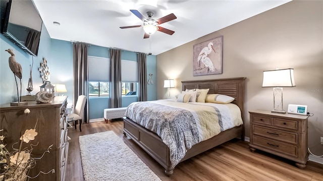 26747 White Plains Way, Leesburg, FL 34748 - bedroom with baseboards, wood finished floors, and ceiling fan