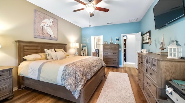 26747 White Plains Way, Leesburg, FL 34748 - bedroom featuring baseboards, visible vents, wood finished floors, and a ceiling fan