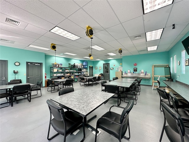 26747 White Plains Way, Leesburg, FL 34748 - dining space featuring a paneled ceiling, visible vents, and finished concrete floors