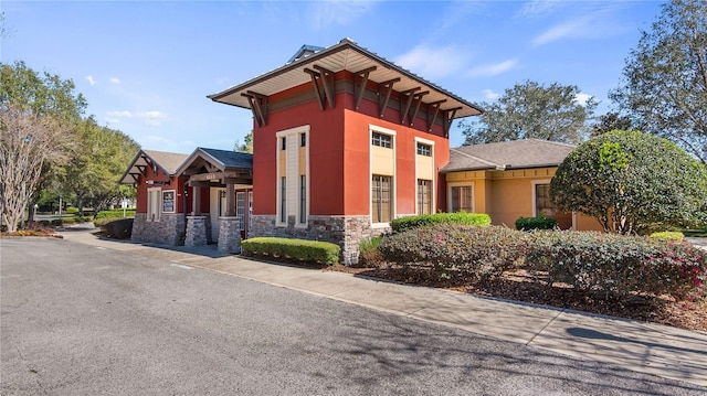 26747 White Plains Way, Leesburg, FL 34748 - exterior space featuring stucco siding and stone siding