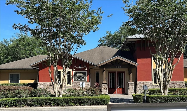 26747 White Plains Way, Leesburg, FL 34748 - craftsman-style home featuring roof with shingles, french doors, stucco siding, and stone siding