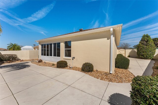 1202 San Bernardo Rd, The Villages, FL 32162 - back of property featuring a fenced backyard, a patio, and stucco siding