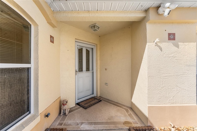 1202 San Bernardo Rd, The Villages, FL 32162 - view of exterior entry featuring stucco siding