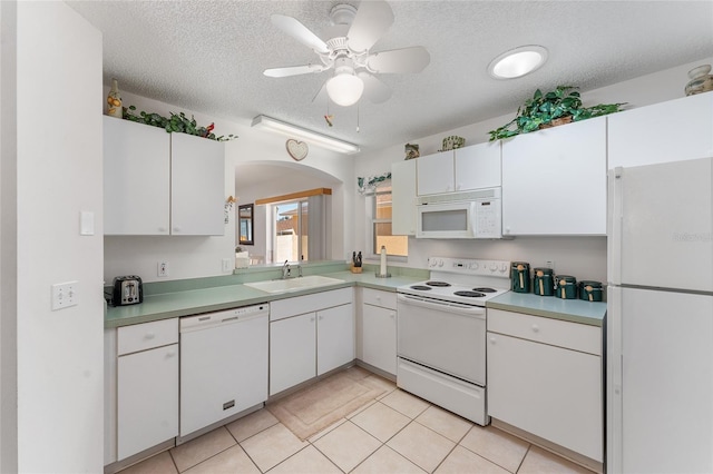 1202 San Bernardo Rd, The Villages, FL 32162 - kitchen featuring white appliances, white cabinetry, and a sink