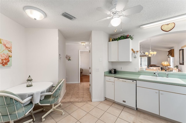 1202 San Bernardo Rd, The Villages, FL 32162 - kitchen featuring light tile patterned floors, visible vents, arched walkways, white dishwasher, and a sink