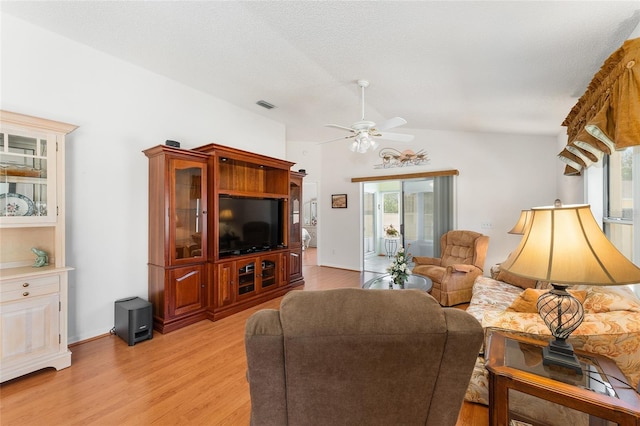 1202 San Bernardo Rd, The Villages, FL 32162 - living area featuring light wood-type flooring, vaulted ceiling, visible vents, and plenty of natural light
