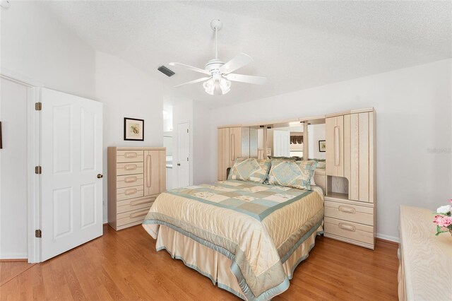 1202 San Bernardo Rd, The Villages, FL 32162 - bedroom featuring a textured ceiling, ceiling fan, and light wood-style flooring
