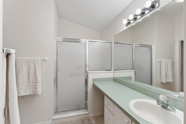 1202 San Bernardo Rd, The Villages, FL 32162 - bathroom with lofted ceiling, a shower stall, a textured ceiling, vanity, and tile patterned flooring