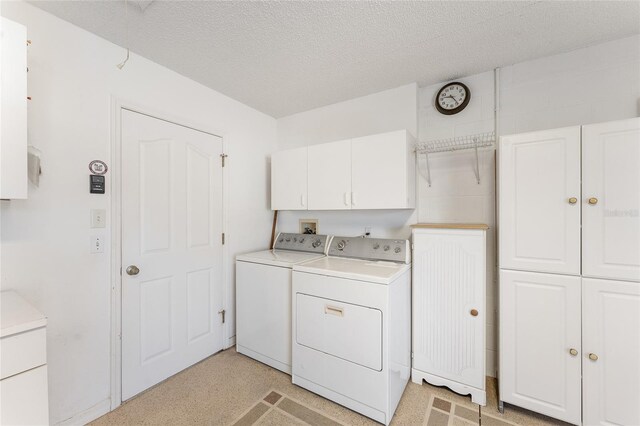 1202 San Bernardo Rd, The Villages, FL 32162 - laundry room featuring a textured ceiling, washing machine and dryer, and cabinet space
