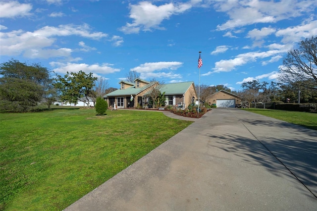 view of front facade with a garage, metal roof, and a front lawn