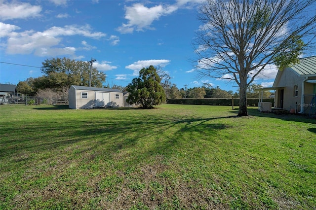 view of yard featuring fence and an outdoor structure