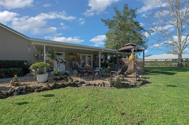 view of yard with a gazebo, french doors, and a patio area