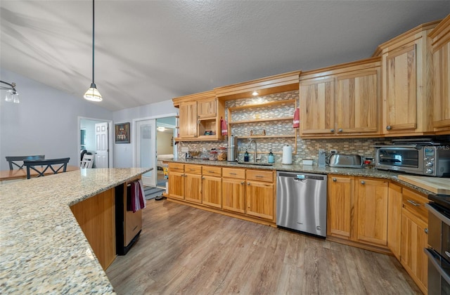 kitchen with a toaster, tasteful backsplash, a sink, light wood-type flooring, and dishwasher