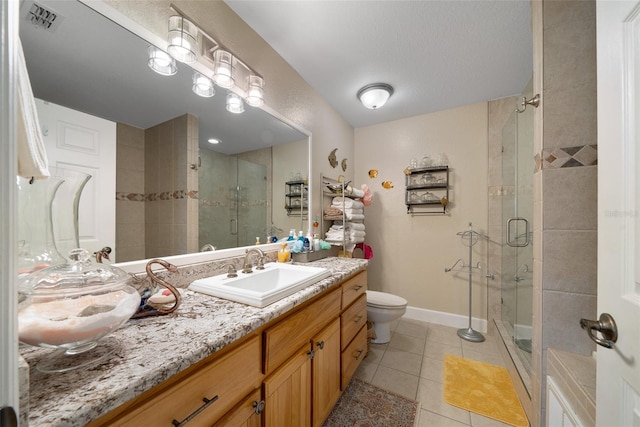 full bathroom with tile patterned flooring, vanity, baseboards, visible vents, and a shower stall