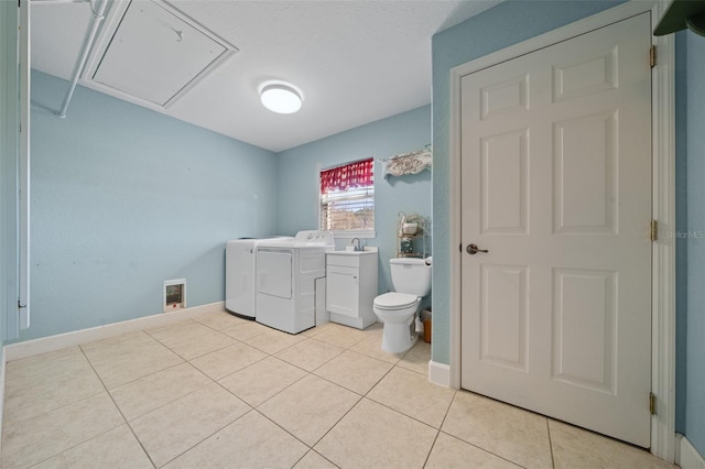 bathroom featuring tile patterned floors, baseboards, toilet, and separate washer and dryer