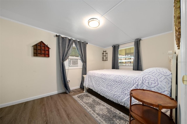 unfurnished bedroom featuring ornamental molding, cooling unit, wood finished floors, and baseboards