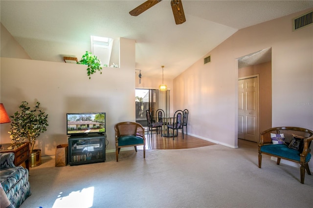 sitting room featuring high vaulted ceiling, carpet flooring, visible vents, and a ceiling fan