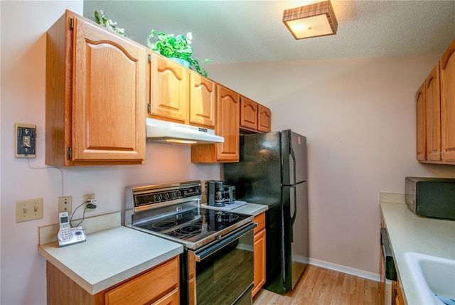 kitchen featuring black microwave, under cabinet range hood, electric stove, light countertops, and light wood finished floors