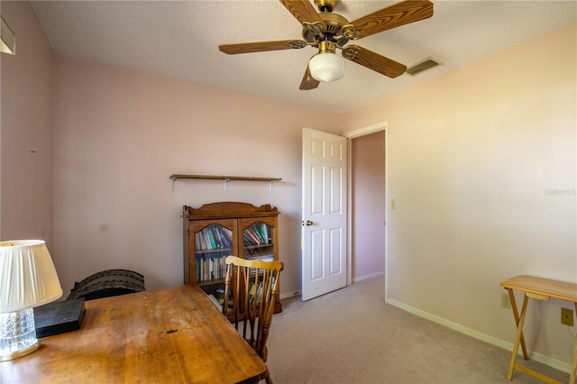 office featuring ceiling fan, carpet, visible vents, and baseboards