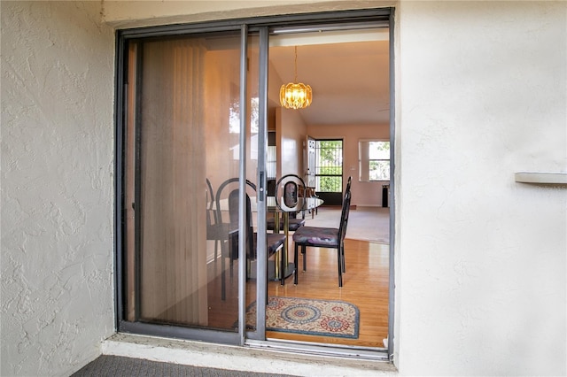 doorway to property featuring stucco siding