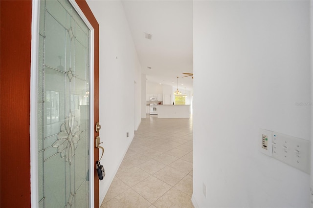 hallway with light tile patterned floors and visible vents