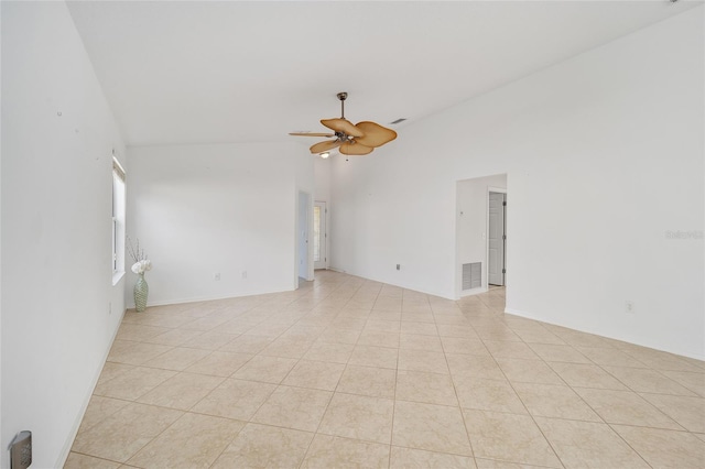 spare room featuring visible vents, vaulted ceiling, a ceiling fan, and light tile patterned flooring