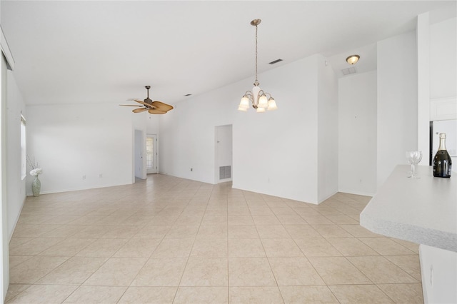 unfurnished room featuring ceiling fan with notable chandelier, light tile patterned floors, vaulted ceiling, and visible vents