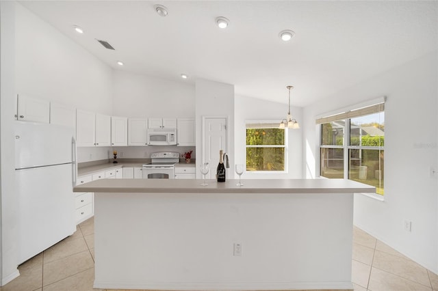 kitchen with light tile patterned floors, lofted ceiling, hanging light fixtures, white cabinetry, and white appliances