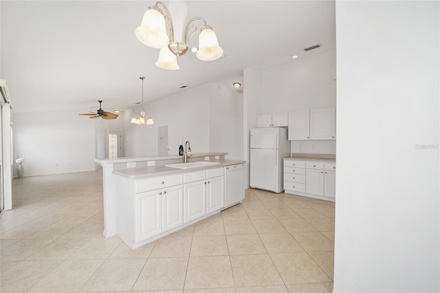 kitchen with light tile patterned floors, open floor plan, white cabinets, a sink, and white appliances