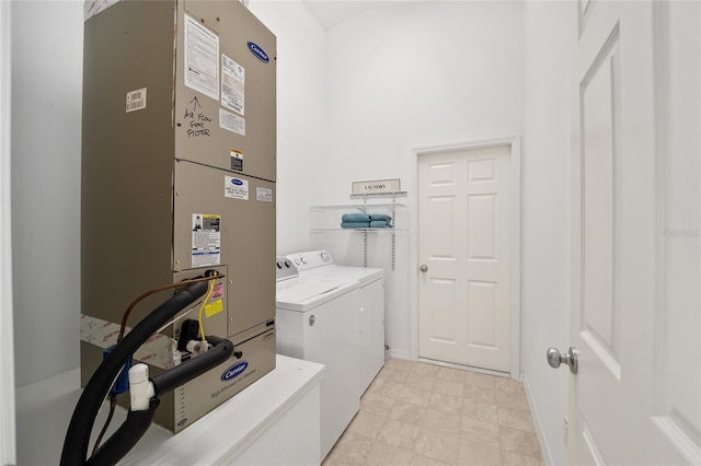 clothes washing area with washing machine and dryer, laundry area, a high ceiling, and heating unit