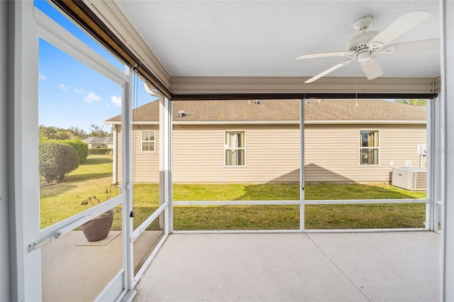 unfurnished sunroom featuring a ceiling fan