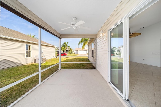 unfurnished sunroom with ceiling fan