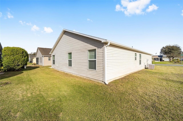 view of property exterior featuring central AC and a yard