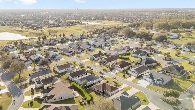 drone / aerial view with a water view and a residential view