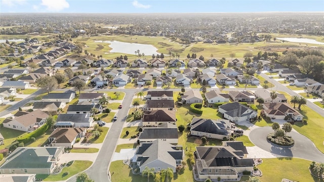 birds eye view of property featuring a water view and a residential view