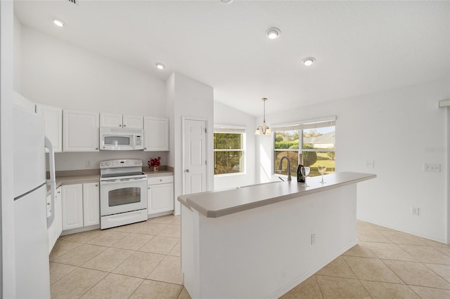 kitchen featuring lofted ceiling, white appliances, light tile patterned floors, and white cabinetry