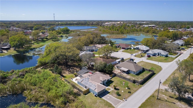 drone / aerial view featuring a water view and a residential view