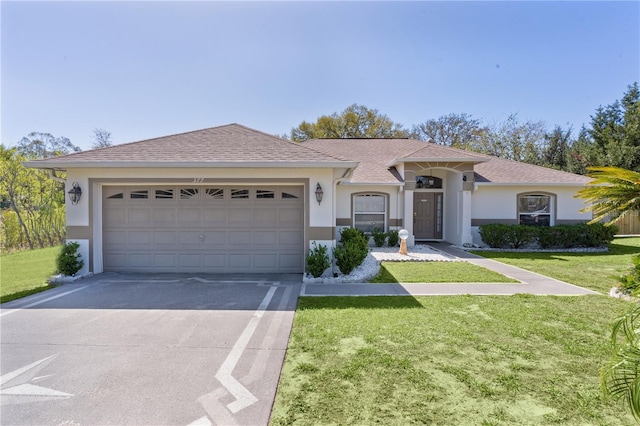 ranch-style home with stucco siding, a shingled roof, concrete driveway, a front yard, and a garage