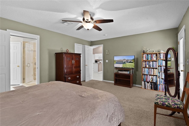 carpeted bedroom with baseboards, visible vents, a ceiling fan, connected bathroom, and a textured ceiling