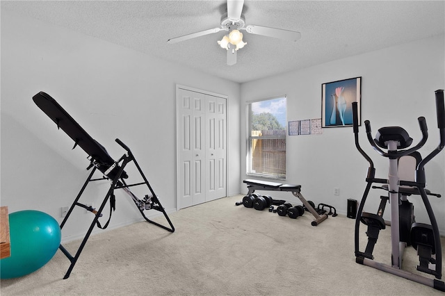 exercise room with carpet floors, ceiling fan, and a textured ceiling