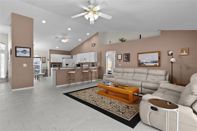 living area featuring baseboards, high vaulted ceiling, a ceiling fan, and recessed lighting