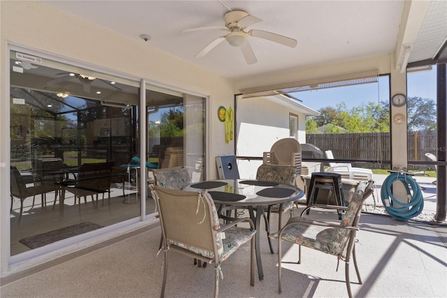 sunroom / solarium with a ceiling fan