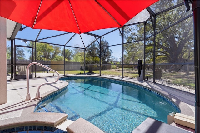 view of pool with glass enclosure, a fenced backyard, a fenced in pool, and a patio