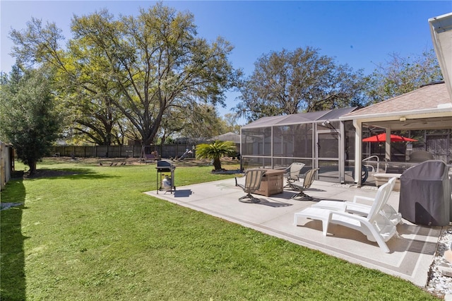 view of yard featuring glass enclosure, a fenced backyard, and a patio