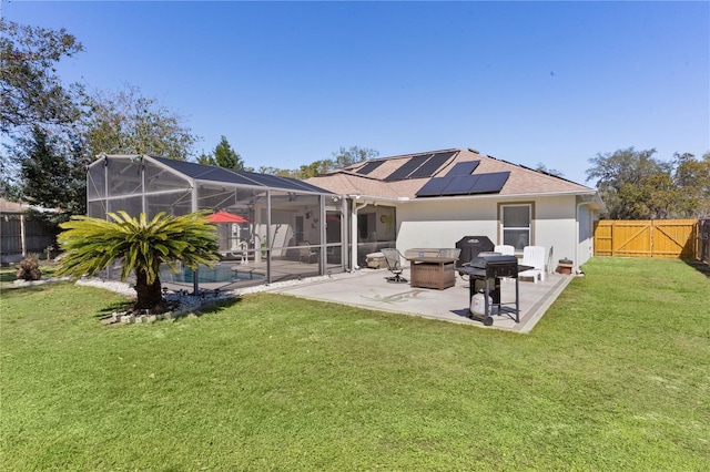 rear view of house featuring a lawn, a patio area, a fenced backyard, and stucco siding